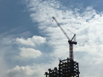 Low angle view of crane against sky