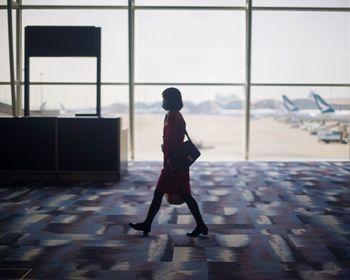 Side view of woman walking at airport