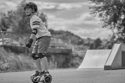 Side view of boy on self-balancing board at park