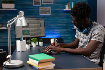 Rear view of man working at table