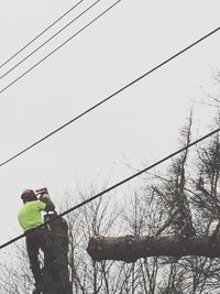 Low angle view of power lines against sky