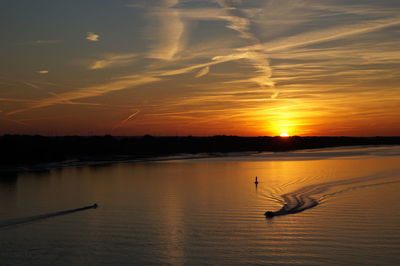 Scenic view of lake against sky during sunset