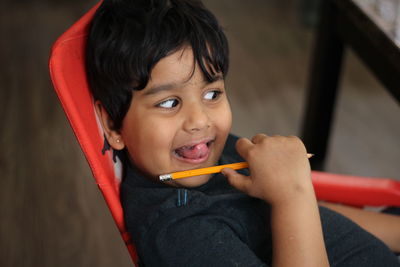 Portrait of smiling boy in chair