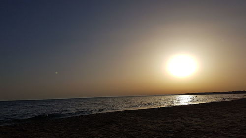 Scenic view of sea against sky at sunset