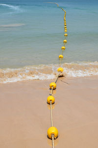 Yellow lights on beach by sea