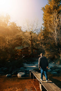 Man walking to a cabin in the mountains