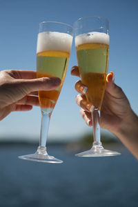 Close-up of hand holding beer glass