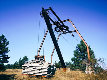 Low angle view of crane against clear sky