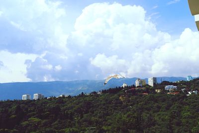 Panoramic view of trees and buildings against sky