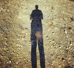 Shadow of woman standing on ground