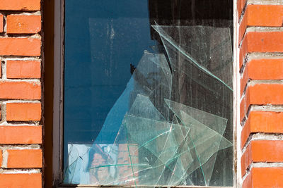 Close-up of broken glass window