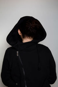 Rear view of man standing against wall
