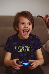 Portrait of boy playing wideo game 