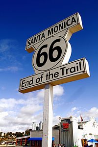 Low angle view of sign board against blue sky