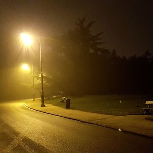 Illuminated road against sky at night