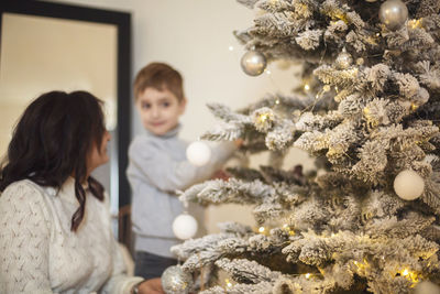 Portrait of cute girl decorating christmas tree