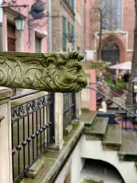 Statue of metal gate against building