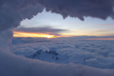 Scenic view of snow landscape against sky during sunset