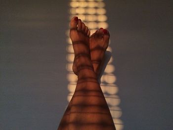 Low section of woman relaxing on floor