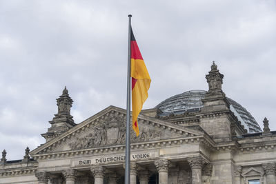 Low angle view of historical building against cloudy sky