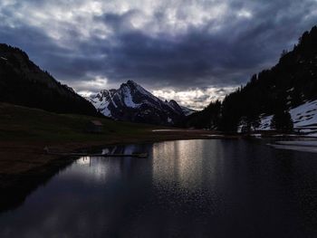 Scenic view of lake and mountains against sky