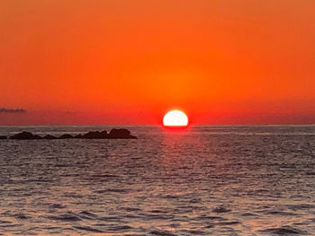 Scenic view of sea against romantic sky at sunset