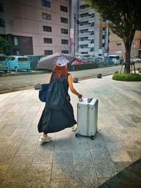 Rear view of woman standing on street