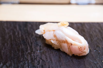 Close-up of sushi on slate