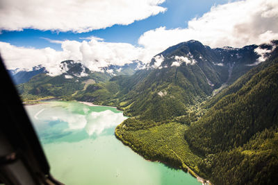 View of lake and mountains out the window of an aircraft.