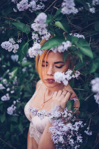 Portrait of beautiful woman with red flower