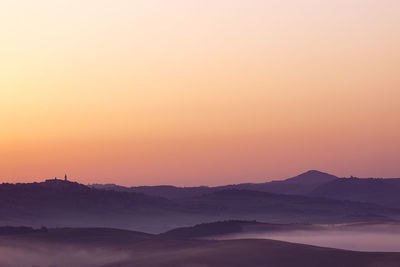 Scenic view of mountains against clear sky during sunset