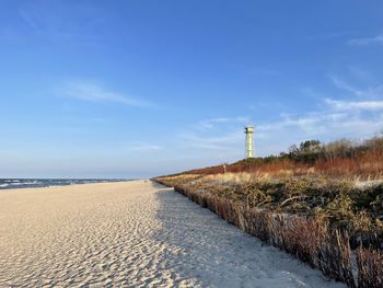 Scenic view of beach against blue sky