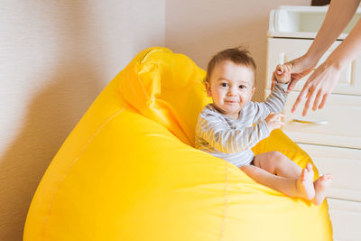 Portrait of cute boy sitting on bean bag