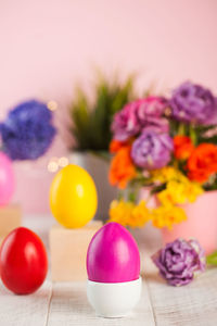 Easter colorful eggs on the background of spring flowers. bright easter concept. copy space.