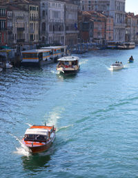 Many boats and taxi in grand canal from rialto bridge in ven