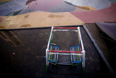 High angle view of multi colored chairs on railing