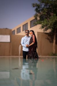 Young couple standing in swimming pool