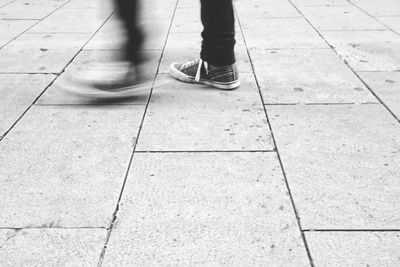 Low section of man standing on tiled floor