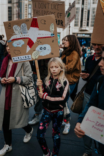 GROUP OF PEOPLE STANDING ON STREET