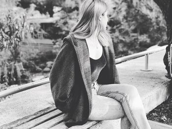 Woman sitting on bench at park