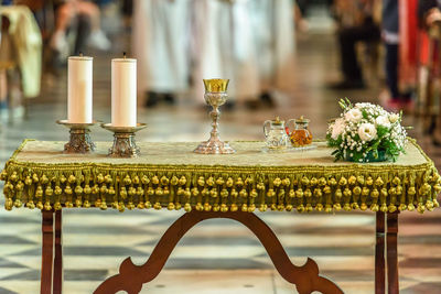 Close-up of wine glass and candles on table at church