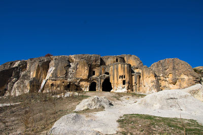 Rock formations against blue sky