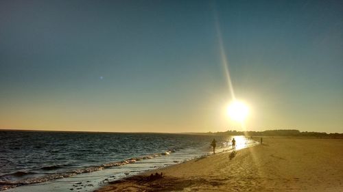 Scenic view of beach against sky during sunset