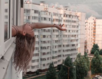 Woman looking at buildings in city