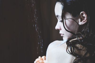 Close-up portrait of a young woman looking away