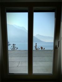 Panoramic view of sea seen through window