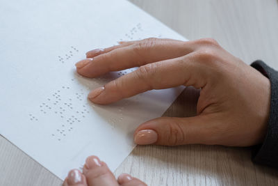 Close-up of hand holding book