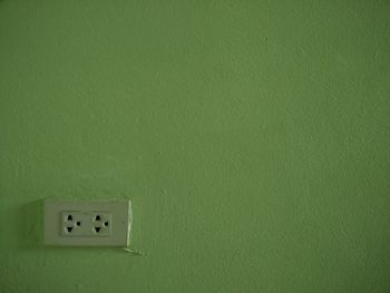 Close-up of electric light on wall