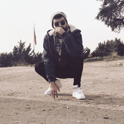 Full length of man wearing sunglasses on field against sky