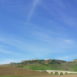 Scenic view of landscape against blue sky